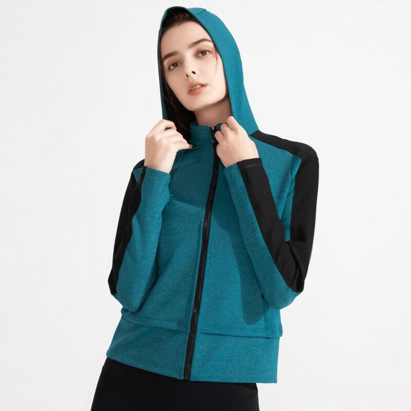 Women's hooded sweatshirt with zipper and thumb holes, ideal for workouts. Made of nylon and spandex for elasticity and quick dry time.